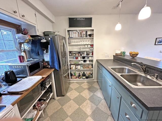 kitchen with decorative light fixtures, sink, and crown molding