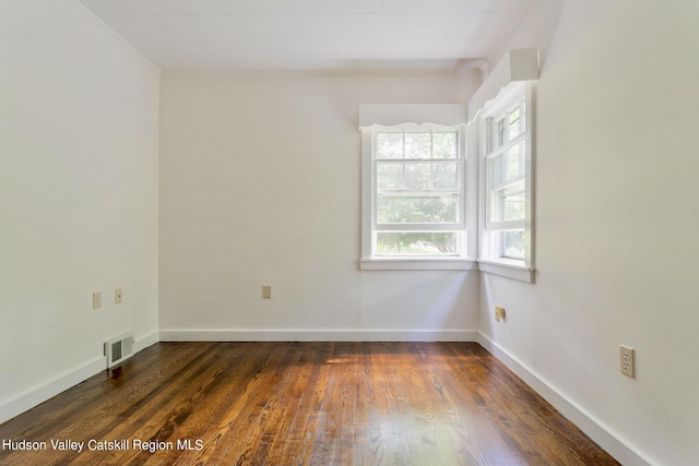 empty room with dark wood-type flooring