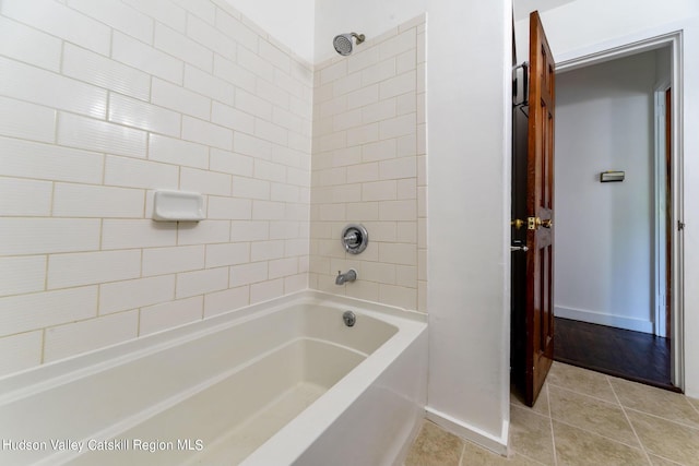 bathroom featuring tiled shower / bath combo and tile patterned floors