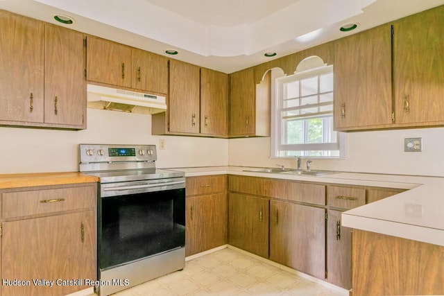 kitchen with electric stove and sink