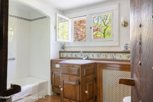 1716 Rte 212, Saugerties, NY 12477 - bathroom with plenty of natural light, vanity, wood finished floors, and toilet