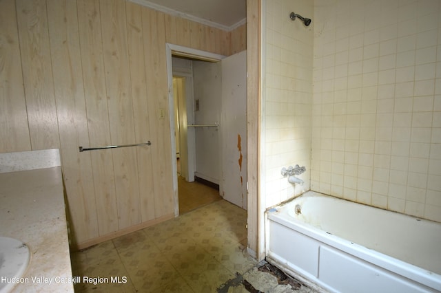 2693 Rte 9w, Saugerties, NY 12477 - bathroom featuring tile patterned floors, wood walls, ornamental molding, vanity, and tub / shower combination