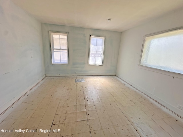 empty room with baseboards and visible vents