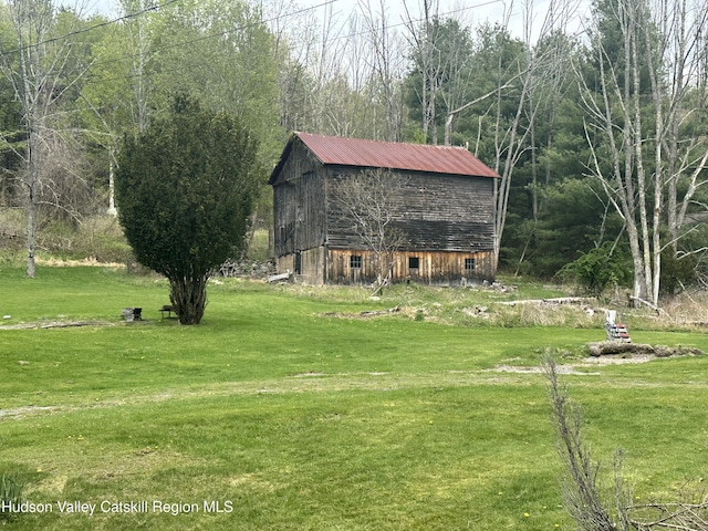 50 Tempaloni Rd, Ellenville, NY 12428 - view of home's exterior with a barn, an outdoor structure, a yard, and metal roof