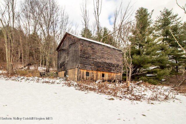50 Tempaloni Rd, Ellenville, NY 12428 - view of snow covered exterior featuring a barn and an outbuilding