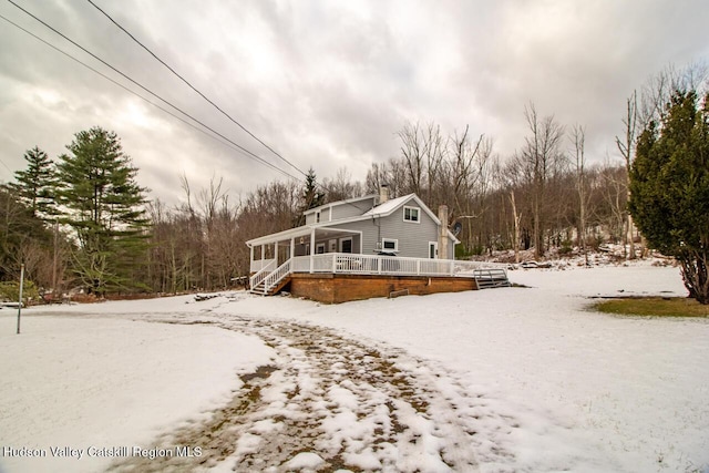 50 Tempaloni Rd, Ellenville, NY 12428 - view of front facade with a sunroom, a chimney, and a wooden deck