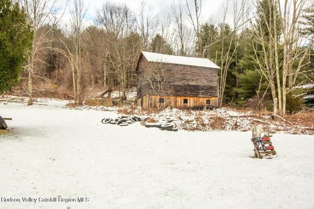 50 Tempaloni Rd, Ellenville, NY 12428 - snowy yard with a barn and an outdoor structure