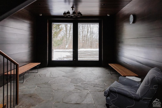 890 Bald Mountain Rd, Austerlitz, NY 12017 - doorway with stone flooring, wooden walls, stairs, and a chandelier