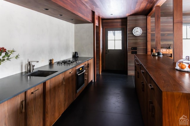 890 Bald Mountain Rd, Austerlitz, NY 12017 - kitchen featuring wall oven, dark countertops, stainless steel gas stovetop, a sink, and healthy amount of natural light