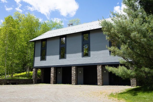 890 Bald Mountain Rd, Austerlitz, NY 12017 - view of front of home featuring stone siding, gravel driveway, and metal roof