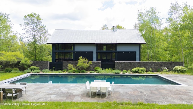 890 Bald Mountain Rd, Austerlitz, NY 12017 - rear view of house with a patio, stone siding, and metal roof