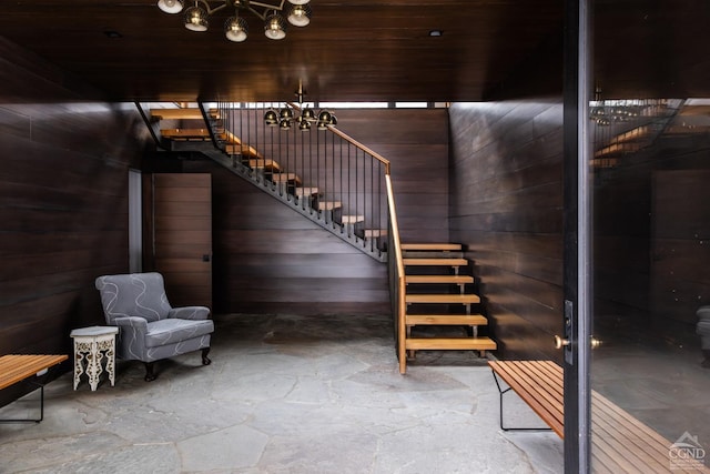 890 Bald Mountain Rd, Austerlitz, NY 12017 - stairs featuring stone flooring, a chandelier, and wood walls