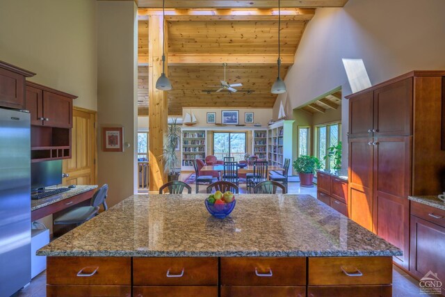 234 Botti Dr, Hunter, NY 12442 - kitchen with high vaulted ceiling, freestanding refrigerator, a kitchen island, plenty of natural light, and stone counters