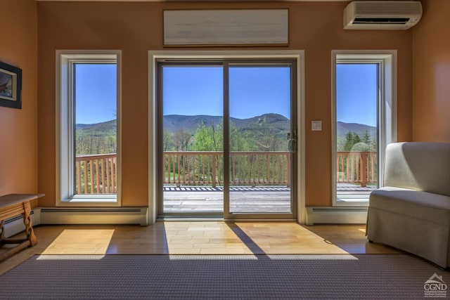 234 Botti Dr, Hunter, NY 12442 - entryway with baseboard heating, a mountain view, a wall unit AC, and wood finished floors