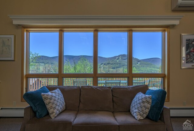 234 Botti Dr, Hunter, NY 12442 - carpeted living area with a baseboard radiator, a mountain view, and a wall mounted air conditioner