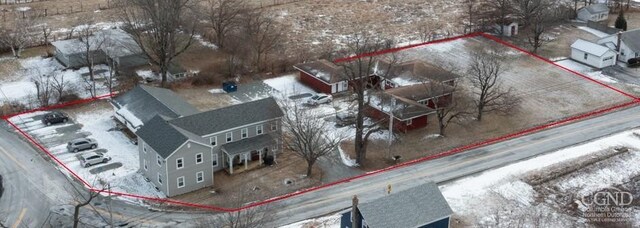snowy aerial view featuring property boundaries highlighted