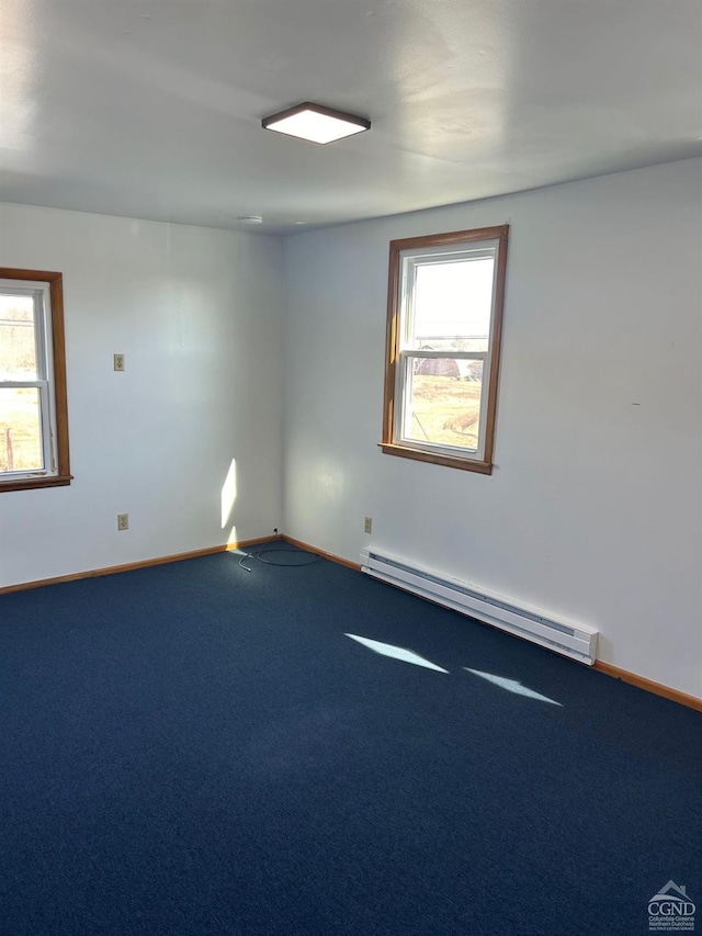 spare room featuring a baseboard radiator, carpet, and baseboards