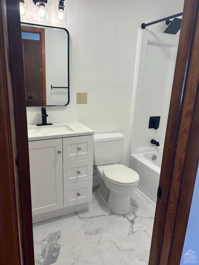 bathroom featuring marble finish floors, vanity, toilet, and washtub / shower combination