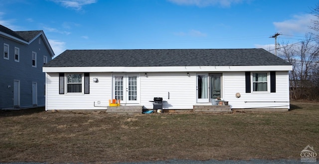 view of front of home with french doors, a front yard, roof with shingles, and entry steps