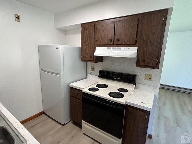 kitchen featuring ventilation hood, electric range, light wood-style flooring, freestanding refrigerator, and light countertops