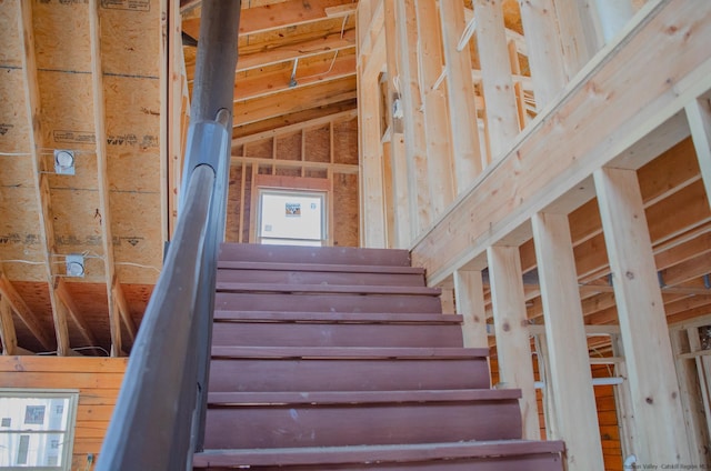 stairway featuring vaulted ceiling