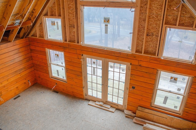 unfurnished living room featuring wooden walls