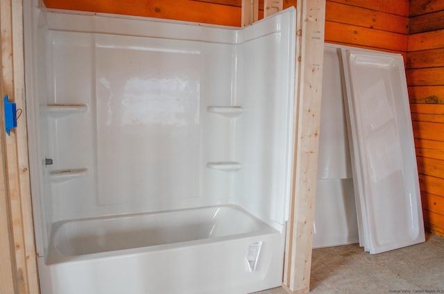 bathroom featuring wood walls