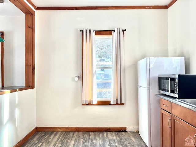 2435 Rte 145, Durham, NY 12423 - kitchen featuring dark wood-type flooring, brown cabinetry, stainless steel microwave, and baseboards