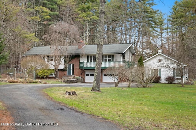 146 Sherman Rd, Kingston, NY 12401 - split foyer home featuring an attached garage, a chimney, driveway, and a front yard