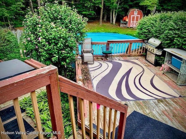 146 Sherman Rd, Kingston, NY 12401 - view of patio / terrace featuring a storage unit, an outdoor structure, a swimming pool, and a deck