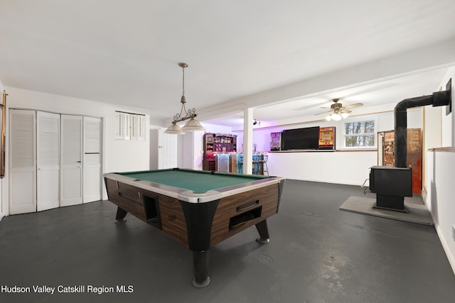 146 Sherman Rd, Kingston, NY 12401 - game room with a wood stove, billiards, concrete flooring, and ceiling fan