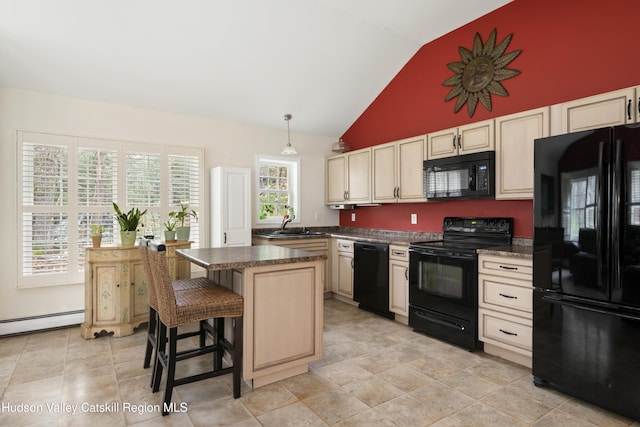 146 Sherman Rd, Kingston, NY 12401 - kitchen with dark countertops, a center island, cream cabinetry, a baseboard radiator, and black appliances