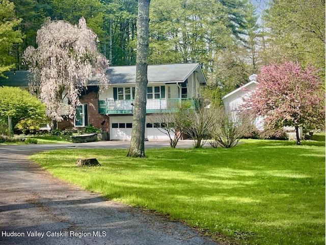 146 Sherman Rd, Kingston, NY 12401 - raised ranch featuring an attached garage, driveway, a balcony, and a front yard