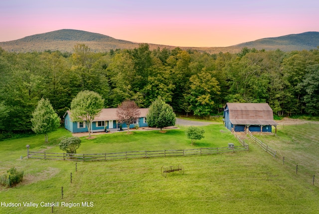 aerial view at dusk with a mountain view and a rural view