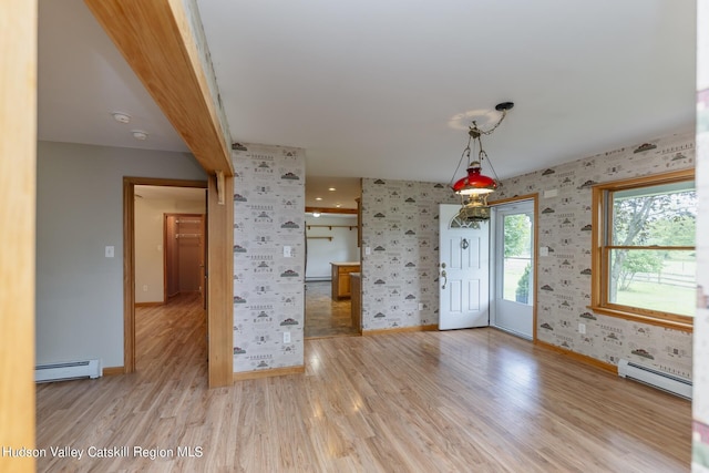 interior space with beam ceiling, light wood-type flooring, and a baseboard radiator