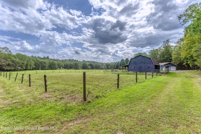 view of yard with an outbuilding and a rural view