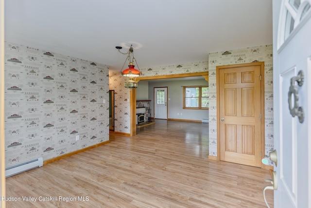 interior space featuring wood-type flooring and baseboard heating