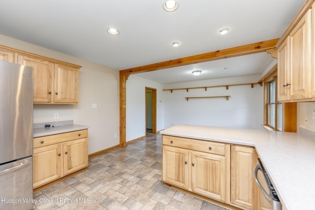 kitchen with light brown cabinets, kitchen peninsula, and stainless steel appliances