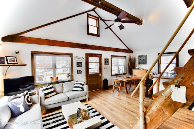 living room featuring beamed ceiling, hardwood / wood-style flooring, high vaulted ceiling, and ceiling fan