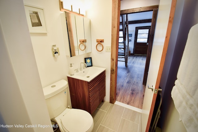 bathroom featuring hardwood / wood-style floors, vanity, and toilet