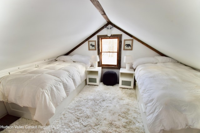 carpeted bedroom with lofted ceiling