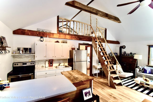 kitchen featuring white cabinets, sink, ceiling fan, light wood-type flooring, and stainless steel appliances