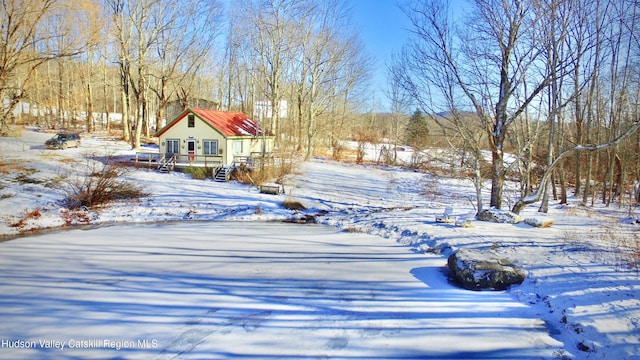 yard covered in snow with a deck