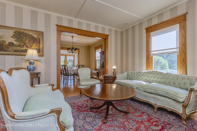 280 Pitcher Ln, Red Hook, NY 12571 - living area with a chandelier, wood finished floors, wallpapered walls, and crown molding