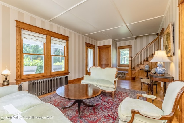 280 Pitcher Ln, Red Hook, NY 12571 - living room with radiator heating unit, wood finished floors, wallpapered walls, stairs, and ornamental molding