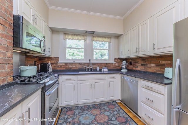 280 Pitcher Ln, Red Hook, NY 12571 - kitchen with stainless steel appliances, crown molding, white cabinetry, and backsplash