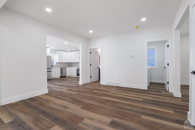 143 Grand St, Schoharie, NY 12157 - unfurnished living room with dark wood-style flooring, recessed lighting, and baseboards