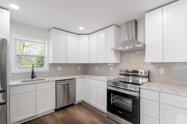 143 Grand St, Schoharie, NY 12157 - kitchen featuring stainless steel appliances, a sink, wall chimney exhaust hood, dark wood finished floors, and decorative backsplash