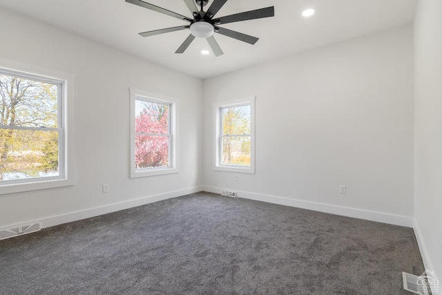 143 Grand St, Schoharie, NY 12157 - empty room featuring healthy amount of natural light, dark colored carpet, recessed lighting, and baseboards