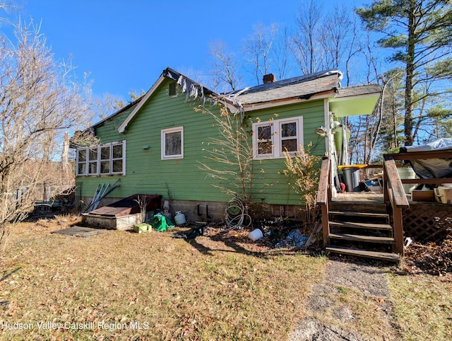 back of house with a deck